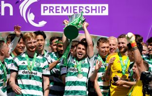 Greg Taylor lifts the cup