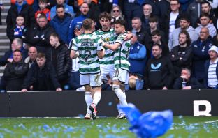Matt O'Riley celebrates with Celtic teammates at Ibrox