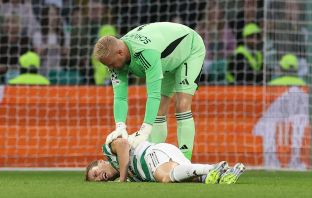 Alistair Johnston of Celtic lies injured
