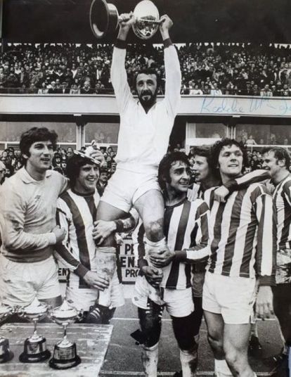 Danny McGrain lifts the trophy