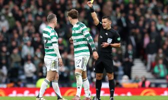Referee Nick Walsh shows a yellow card to Arne Engels